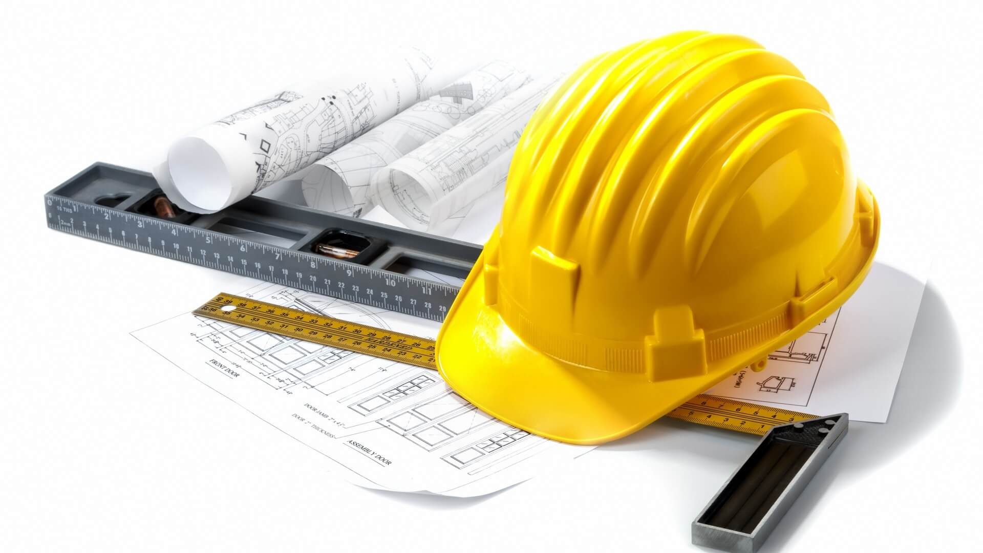 isolated hard hat with blueprints and rulers on white